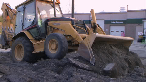 Backhoe Loader Pushing Pavement